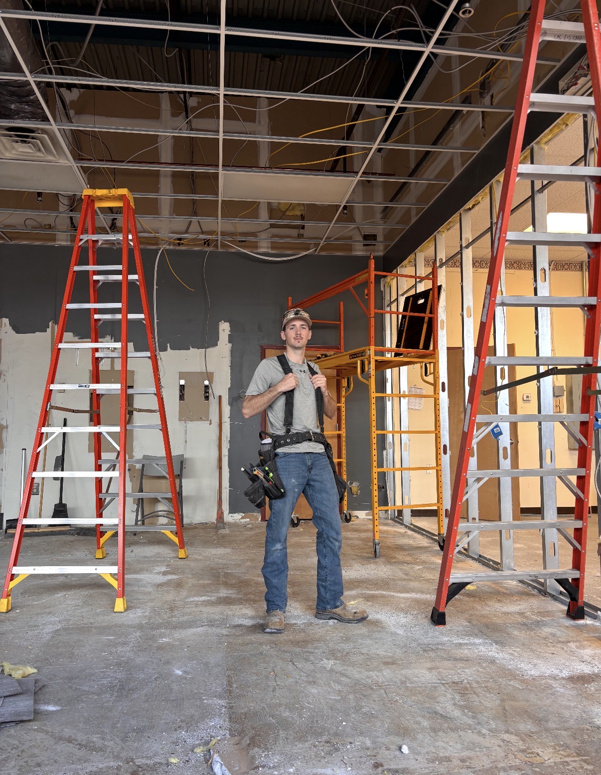 Scott Wiltshire in the Williamson College of the Trades workshop next to a custom-built corner cabinet
