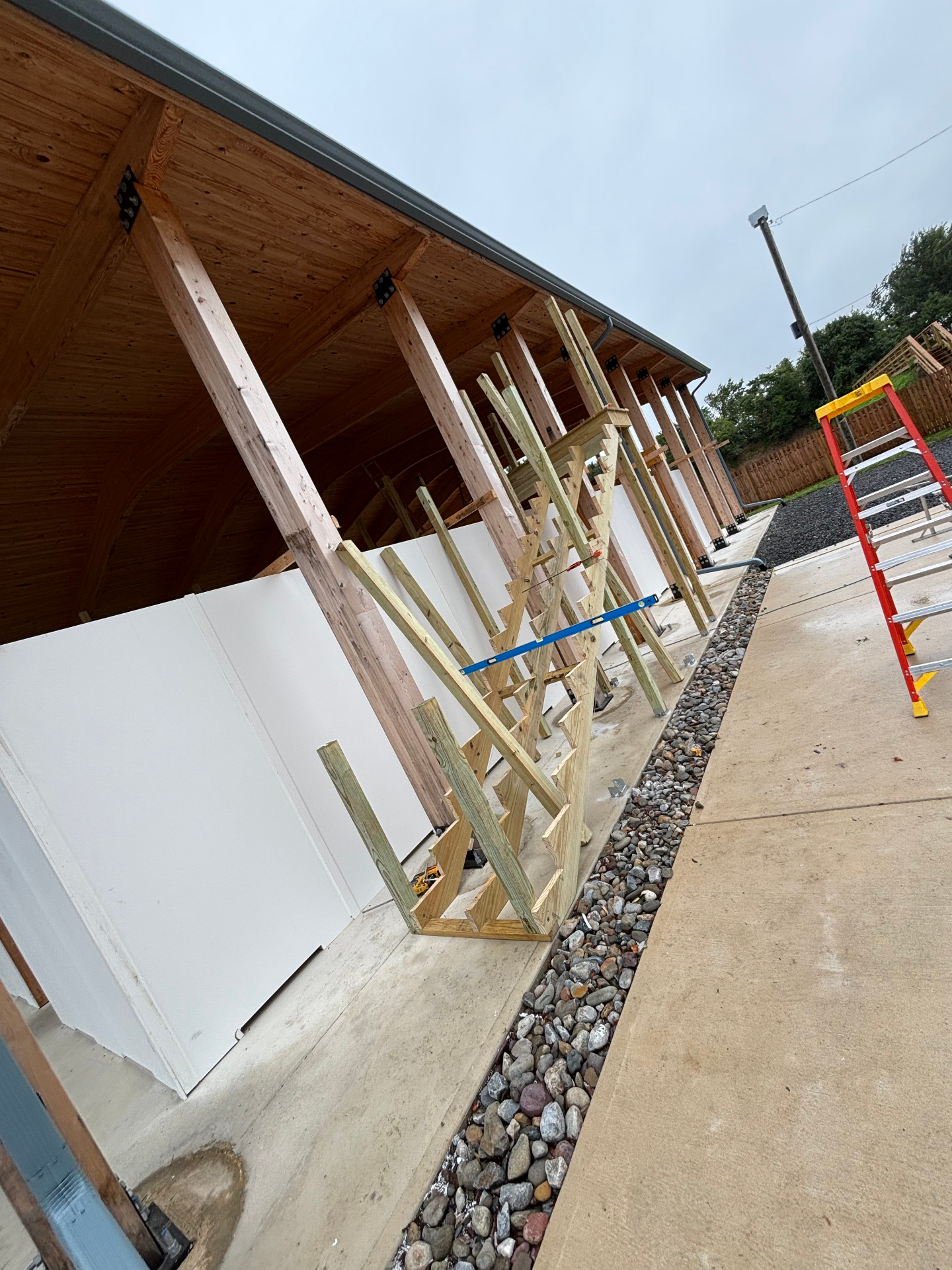 Long view of the pavilion column line and glulam roof structure during build