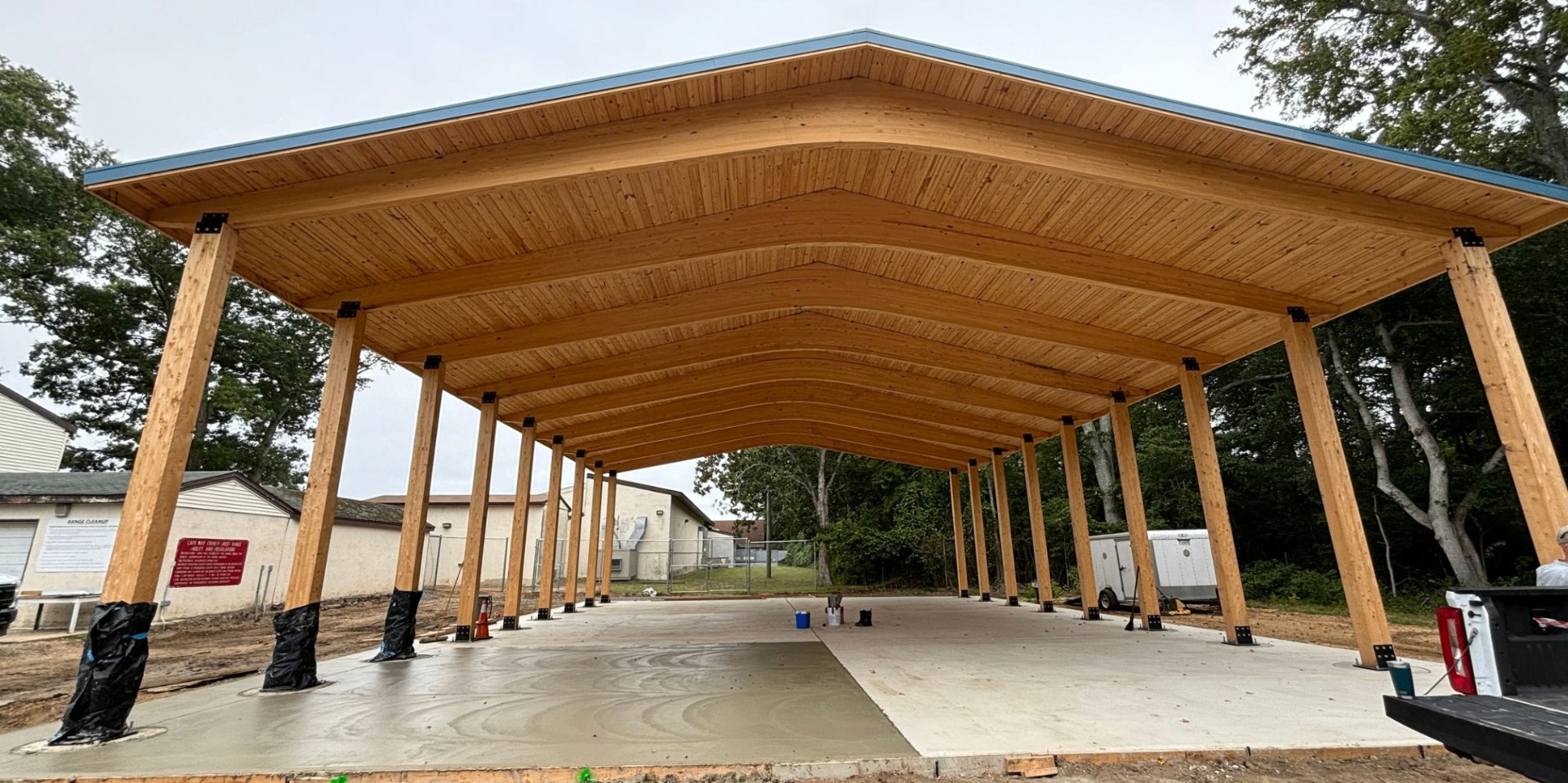 Completed 4,800 square foot timber pavilion with glulam beams and a fresh concrete slab